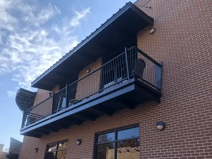 Bordinos: black steel balconies freshly painted against red brick