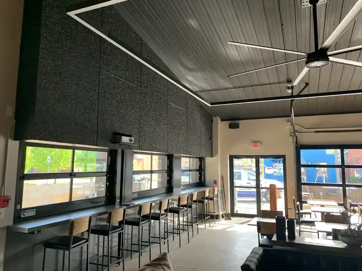 The Hub in Bentonville: bar counter against a dark acoustic wall
