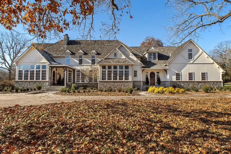 The Sonora project: a stone and stucco estate with a wreathed arched door, after Schneider Painting finished it